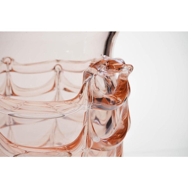 This large vase features a Cordone a Fenicio finish. It has a big spiral bead that is pulled vertically to form decorative...