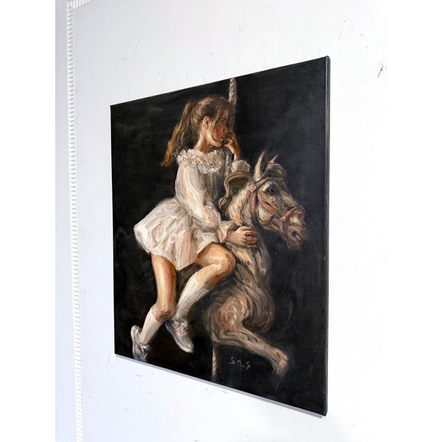 In this evocative artwork, a young girl is captured in an ethereal moment as she sits poised on a carousel horse. Her...