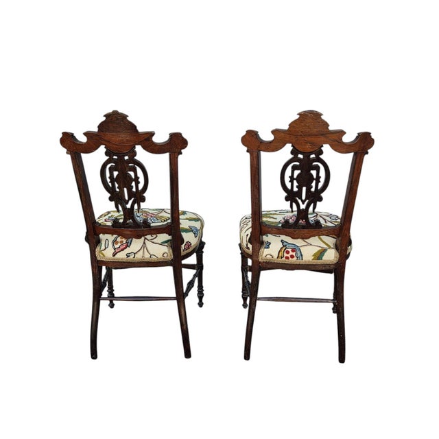 This product is a pair of 19th century rosewood Princess chairs with heavily carved detail. These antique armless chairs...