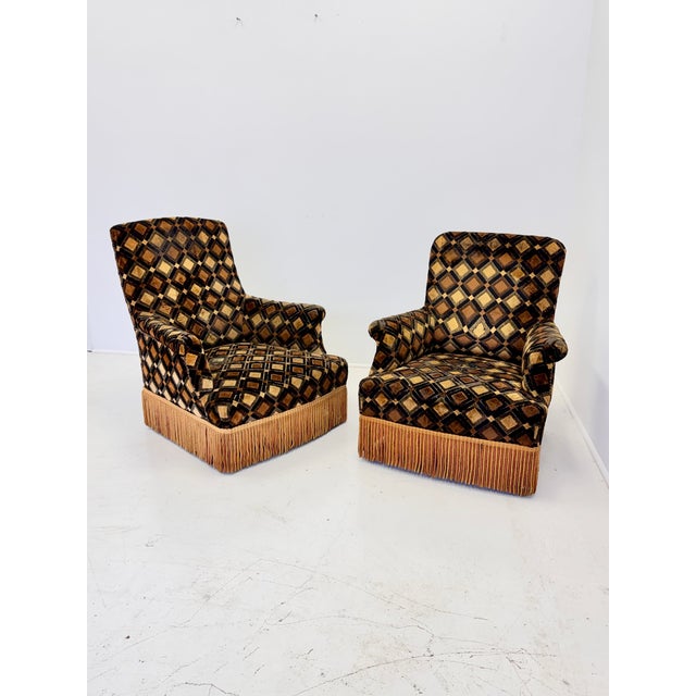 A wonderfully spirited pair of French Art Deco His-and-Hers armchairs dating to the 1930s, retaining their original...
