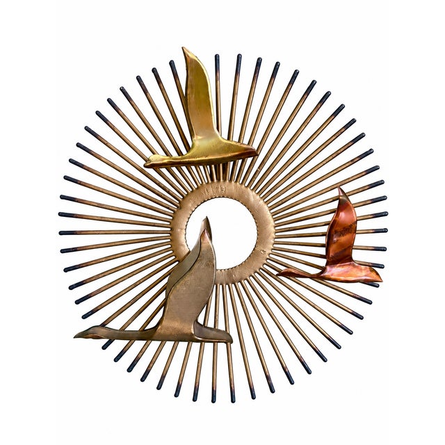 An exceptional matching pair of circa 1970s Mid-Century Modern Brutalist sunburst wall sculptures, distinguished by their...