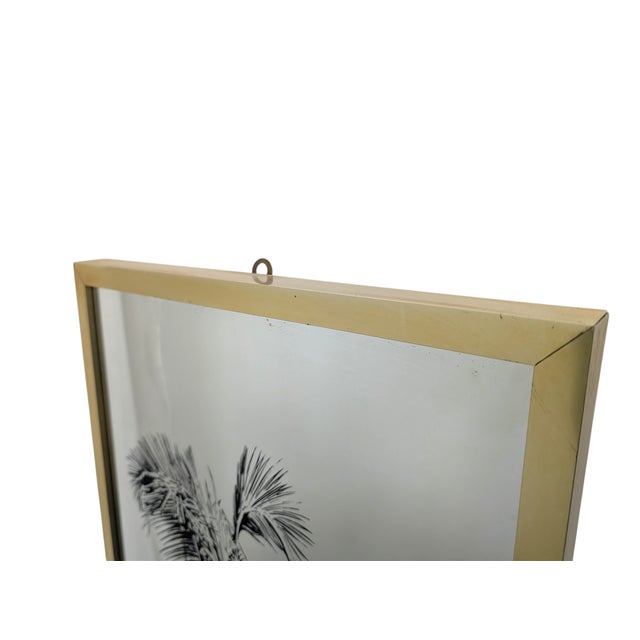 This refined Hollywood Regency-style decorative mirror features a slender rectangular silhouette, embellished with a fine...