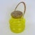 Japanese jar in electric yellow glass with hoop design, large cork stopper and rattan handle, imported for Takahashi....