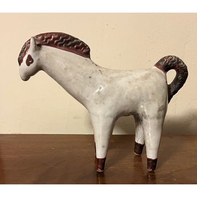 Italian Mid-Century Modern pottery horse sculpture circa 1960. With mane and tail in copper luster; the body a mottled...