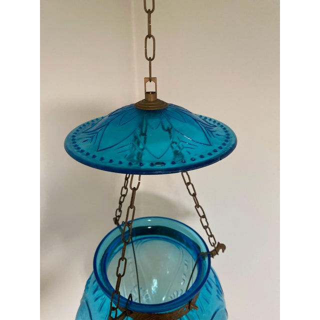 Beautiful and rare antique blue glass hanging lantern in perfect condition. Candle holder inside.
