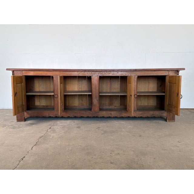 A sculptural and narrative-driven 20th-century enfilade/sideboard that beautifully bridges the gap between traditional...