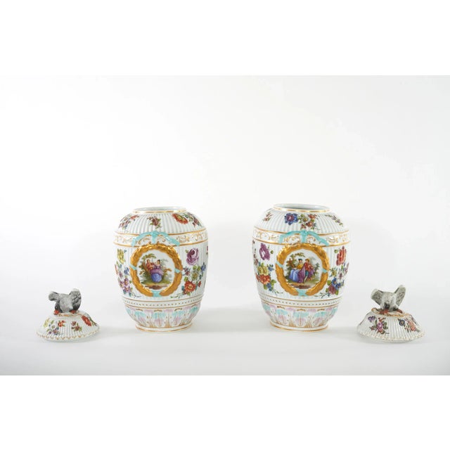19th century German pair glazed porcelain covered decorative urns / vases. Each urn featuring exterior painted scene...