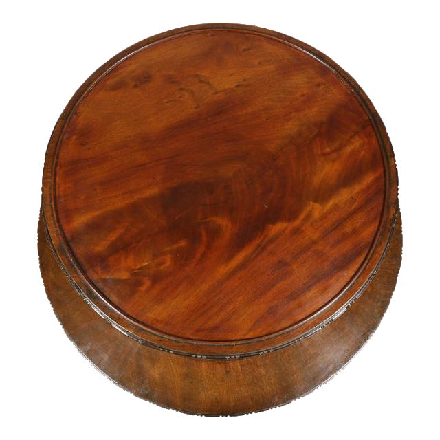 Two-tier with each section revolving, leather book spines alternating with shelving.