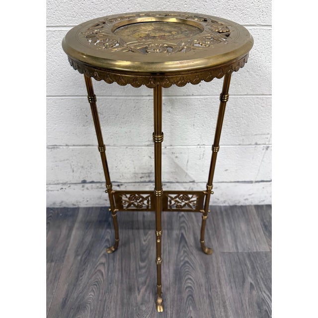 This is a beautiful vintage Hollywood Regency Chinoiserie style brass pedestal plant stand or accent table. It features...