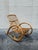 A sculptural vintage rattan rocking chair in the style of Franco Albini, defined by its fluid bentwood lines and signature...