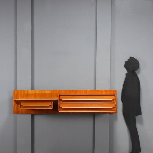 Wall unit in mahogany veneer and part of the top with back-treated glass. This piece is attributed to the mentioned...