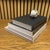A refined, professionally curated Nantucket-style decorative book stack finished with an original Cheryl Fudge shell...