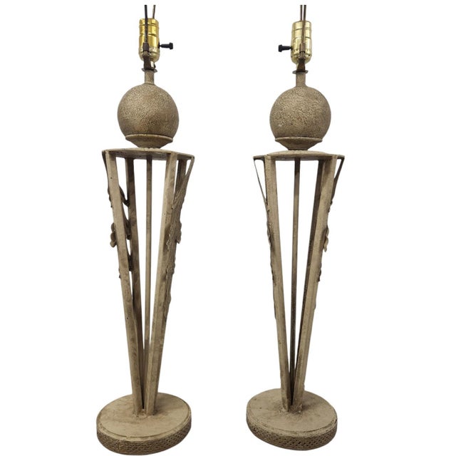 Striking pair of late 20th-century Neoclassical metal table lamps featuring an antiqued faux stone finish, ornate acanthus...