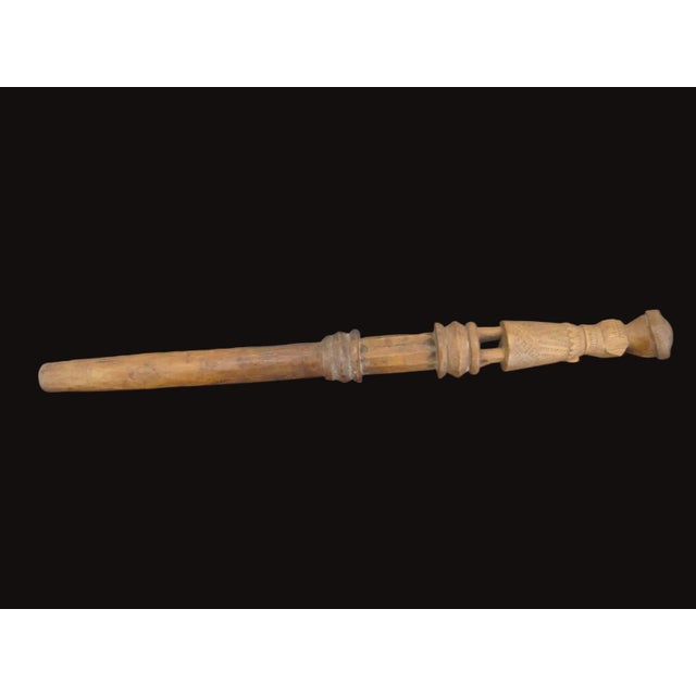 Carved wood distaff or maybe pestle. Stylized anthropomorphic figure featuring a defined human face and carved details on...