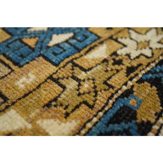 Adapted from a flat-woven Sumac rug design, this east Caucasian scatter shows a single reticulated medium blue faceted...