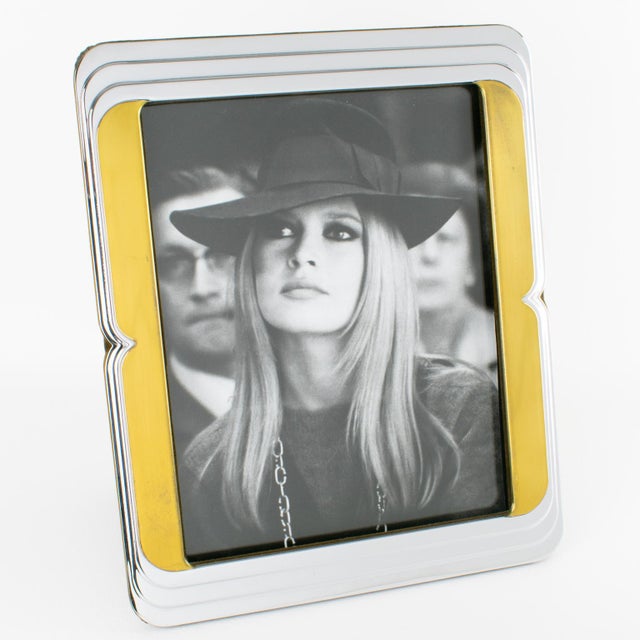 This stunning Noel BC chrome-and-brass picture frame is perfect for adding a touch of luxury to any interior. The piece...