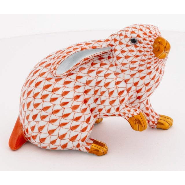 Two Herend Rust Fishnet Porcelain Rabbit Figurines, one bunny with paw up, model 5335, and a seated hare, model 5527, each...