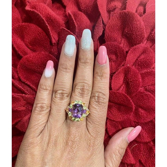 This ring has a beautiful dark purple Cushion Cut Amethyst that weighs 3.77 Carats in the center of the ring and is...