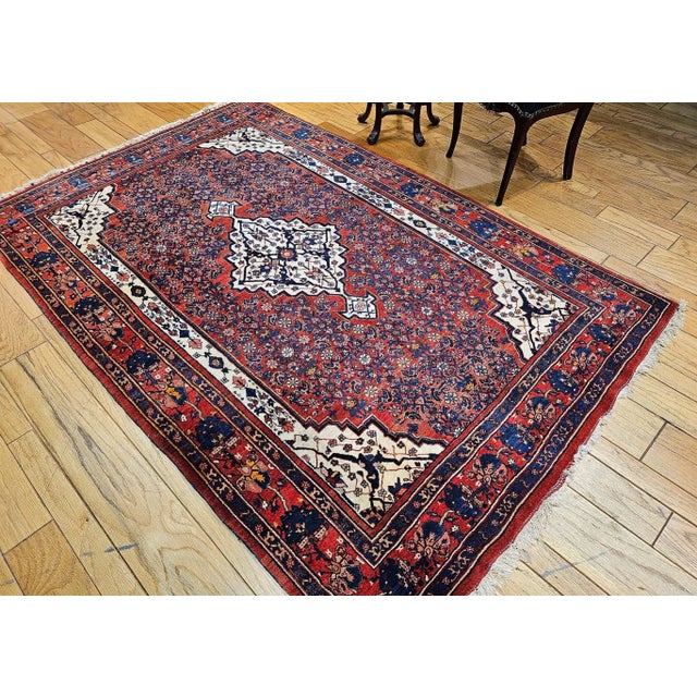 5’ 3” x 8’ 1” Vintage Persian Bidjar area rug from the early 20th century in a medallion pattern set on a Herati field...