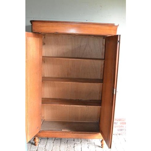 19th-century Dutch oak Biedermeier maid's wardrobe. Height: 179 cm. Width: 117 cm. Depth: 43 cm. One drawer at the top....