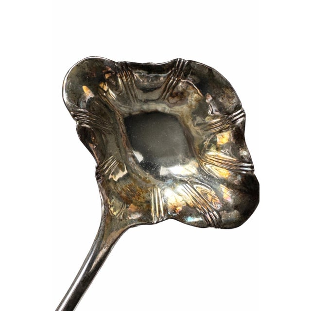 Vintage Italian silver plate ladle featuring a sculpted shell bowl and tapered handle. Marked Italy. Lovely natural patina...
