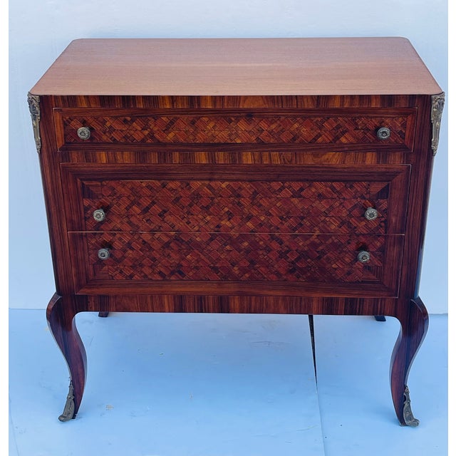 Beautiful marquetry inlaid French antique Louis XVI commode with three drawers on cabriole legs, with bronze accents and...