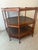 Beautiful Baker furniture three-tier octagonal walnut and cane side table. The tables defining element is the bookmarked...
