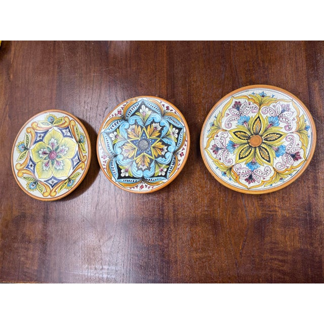 Design Plus Gallery presents a Circa 1990s Set of Three Hand Painted Wall Plates from Ceramic Erincina. Each plate is...
