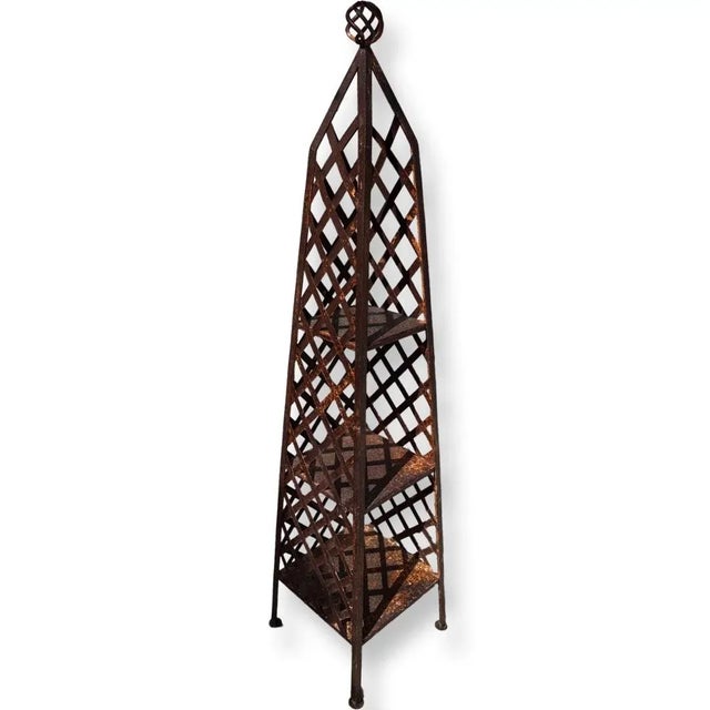 Vintage Italian rusty iron obelisk sculpture can be used as an interior library or as an exterior sculpture for plants.