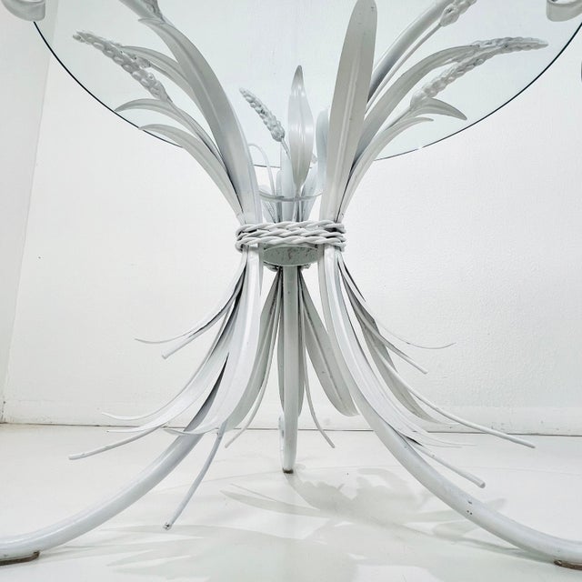 Lovely pair of sculptural metal sheaf of wheat side/end tables with round glass tops. Styled after the famous Coco Chanel...