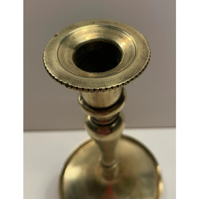 19th century brass candlestick, baluster form, pan base and tooled candle cup rim. Threaded construction. Unmarked,...