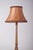 This elegant English floor lamp features a gilded wooden structure, finely crafted with decorative details that embody the...