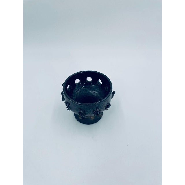 A decorative, artistic vintage-style candle holder made of high-quality ceramic. This cup-shaped, hand-formed candle...
