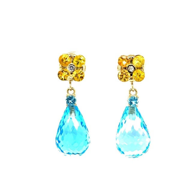26.70 Carat Blue Topaz Yellow Sapphire Yellow Gold Drop Earrings These earrings have 2 Faceted Briolette Blue Topaz stones...