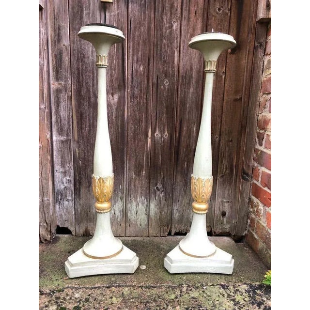 A gorgeous pair of 19th century french carved wood floor standing candlesticks. H 36 in. X w 10 in. X d 10 in. H 91.44 cm...