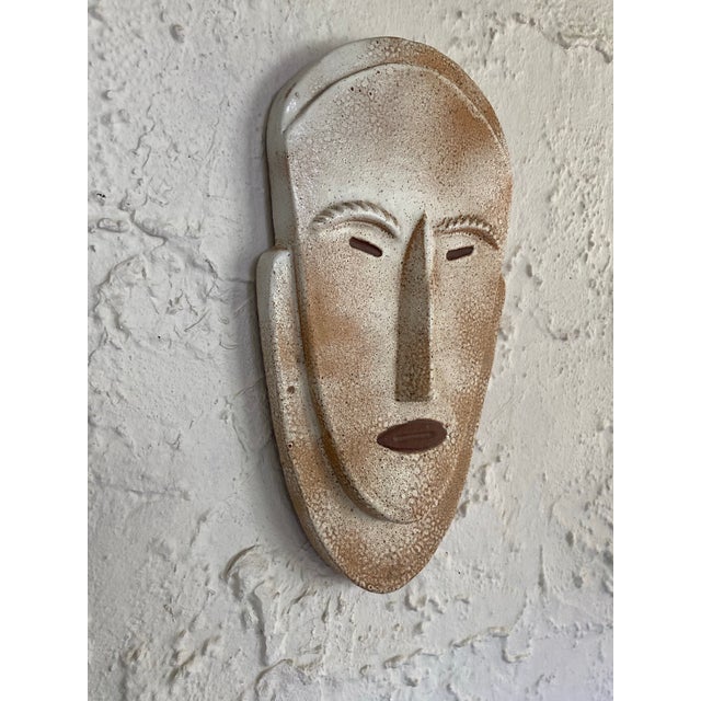 Crafted by Douglas Ferguson co-founder of Pigeon Forge Pottery. An African inspired sculptural wall hanging mask. Pieces...