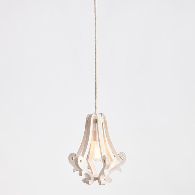 A carved design and simple silhouette makes this a modern take on a traditional scroll design. The jute wrapped chain...