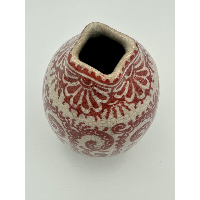 A stunning rare vintage Dutch Delft art pottery vase decorated in red on a craquelé ground by the renowned pottery De...