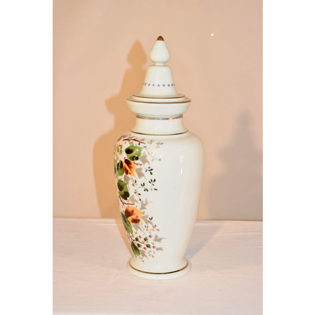 Late 19th century opaline glass lidded urn from France with wonderfully hand painted florals and vines.