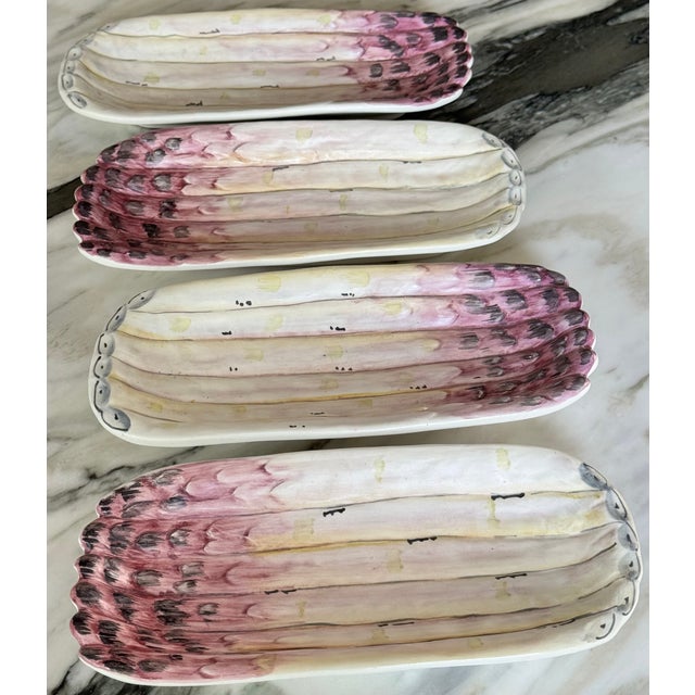 Presenting a set of four asparagus motif serving dishes hand painted in Italy. In raspberry, mauve, whites, greys and...