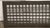 Reclaimed rectangular black steel grate. The original mounting screws are not available. Good condition with surface wear...