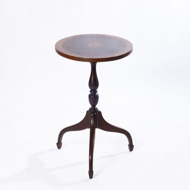 Inlaid mahogany tilt-top table. Wonderful design and cuts on this piece. Great side table for dining and living room.