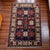 This antique Caucasian Kazak hand‑knotted rug displays a structured field with repeated octagonal medallions and geometric...