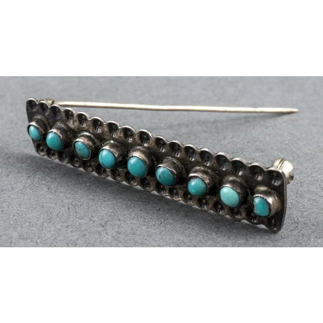 Southwest Native American silver turquoise brooch/pin, comprise of nine 3mm round cabochon-cut turquoise stones; 2.0"L x...