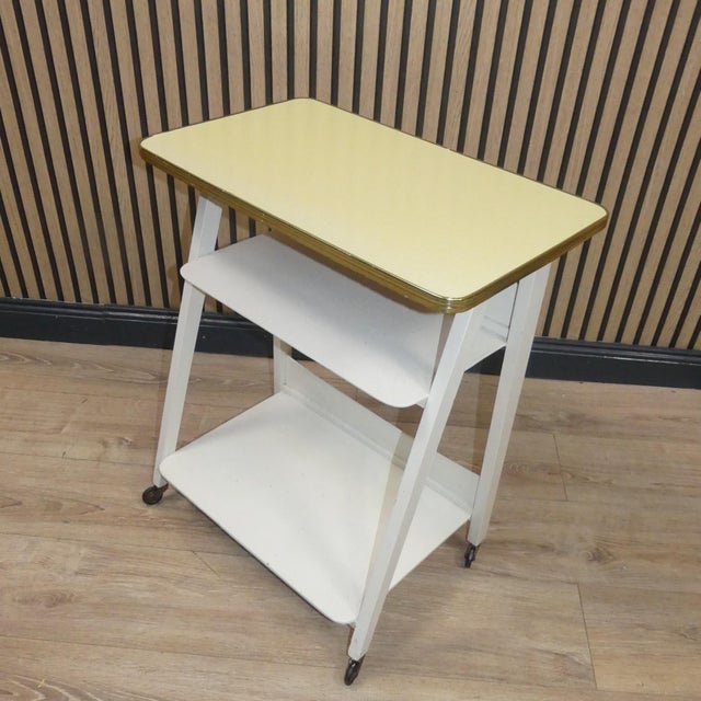 Super shapely piece of furniture Practical side table three-story rollable 50s Upper shelf Formica in pastel yellow with a...