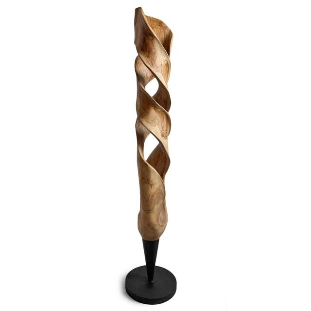 This mahogany wood sculpture features an organic, twisting form with sweeping curves and sculptural openings that...