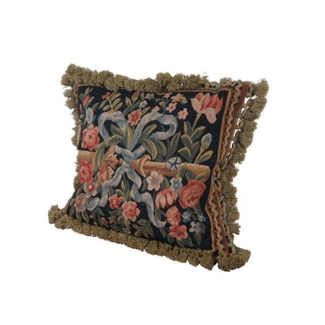 20th century square throw pillow, embroidered with blue flowers and pink roses on leafy stems, surrounding a golden bar...