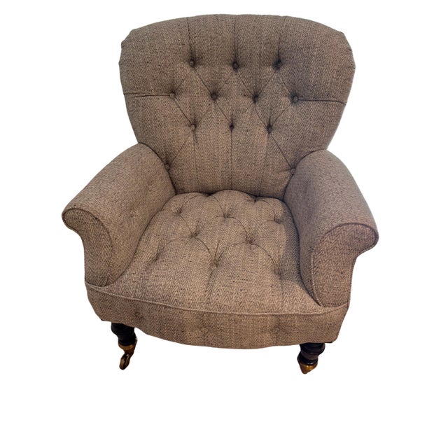 Ralph Lauren Home English style armchair with deep diamond button tufting, rolled arms with piping and dark mahogany front...