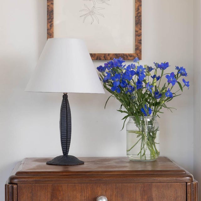 Beautiful Art Nouveau French iron table lamp from the 1920s. Iron body with textured grooves on curvy stem and circular...