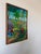 Vibrant vintage Haitian oil painting featuring a lively tropical village landscape, signed “Michelet.” Executed in a...